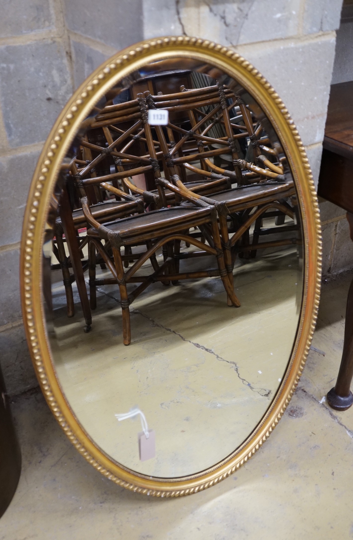 An oval gilt framed wall mirror, width 66cm, height 98cm